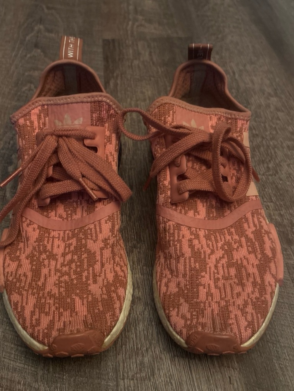 Adidas Women’s Raw Pink & Black NMD R1 sneakers.